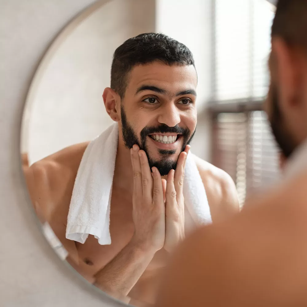 onfident-young-arab-guy-looking-in-the-mirror